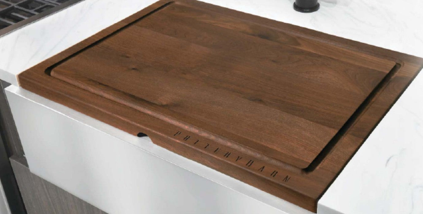 Custom Pottery Barn Walnut sink cover fitted over the sink in an Airstream kitchen