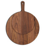 Walnut round pizza paddle shown with grooved serving-board comparison.