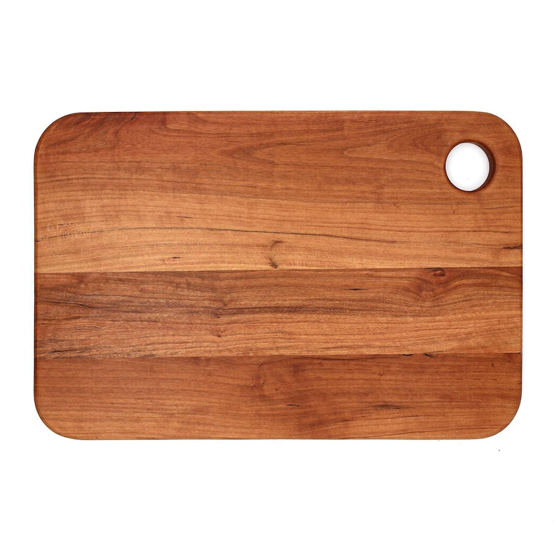 Cherry thumb-hole cutting board plain reverse face, top view.