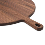 Walnut round pizza paddle handle and edge detail.