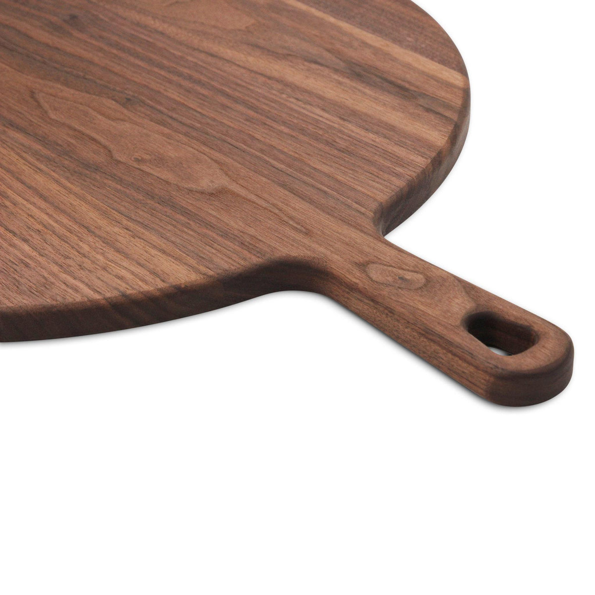 Walnut round pizza paddle handle and edge detail.