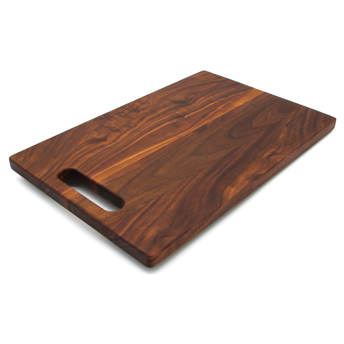 Walnut 16 × 10.5 single-handle cutting board, angled view