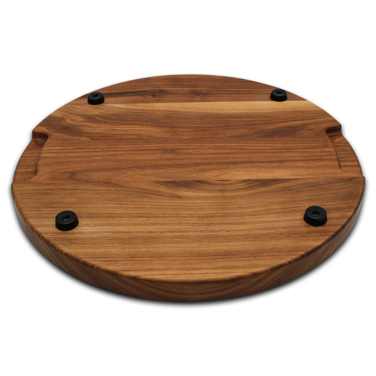 Walnut 18-inch thick round cutting board underside with four black rubber feet, angled view.