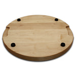 Maple 18-inch thick round cutting board underside with four black rubber feet, angled view.
