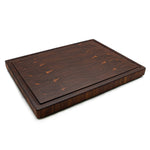 Walnut 20 × 15 end-grain cutting board with juice groove, angled view on white.