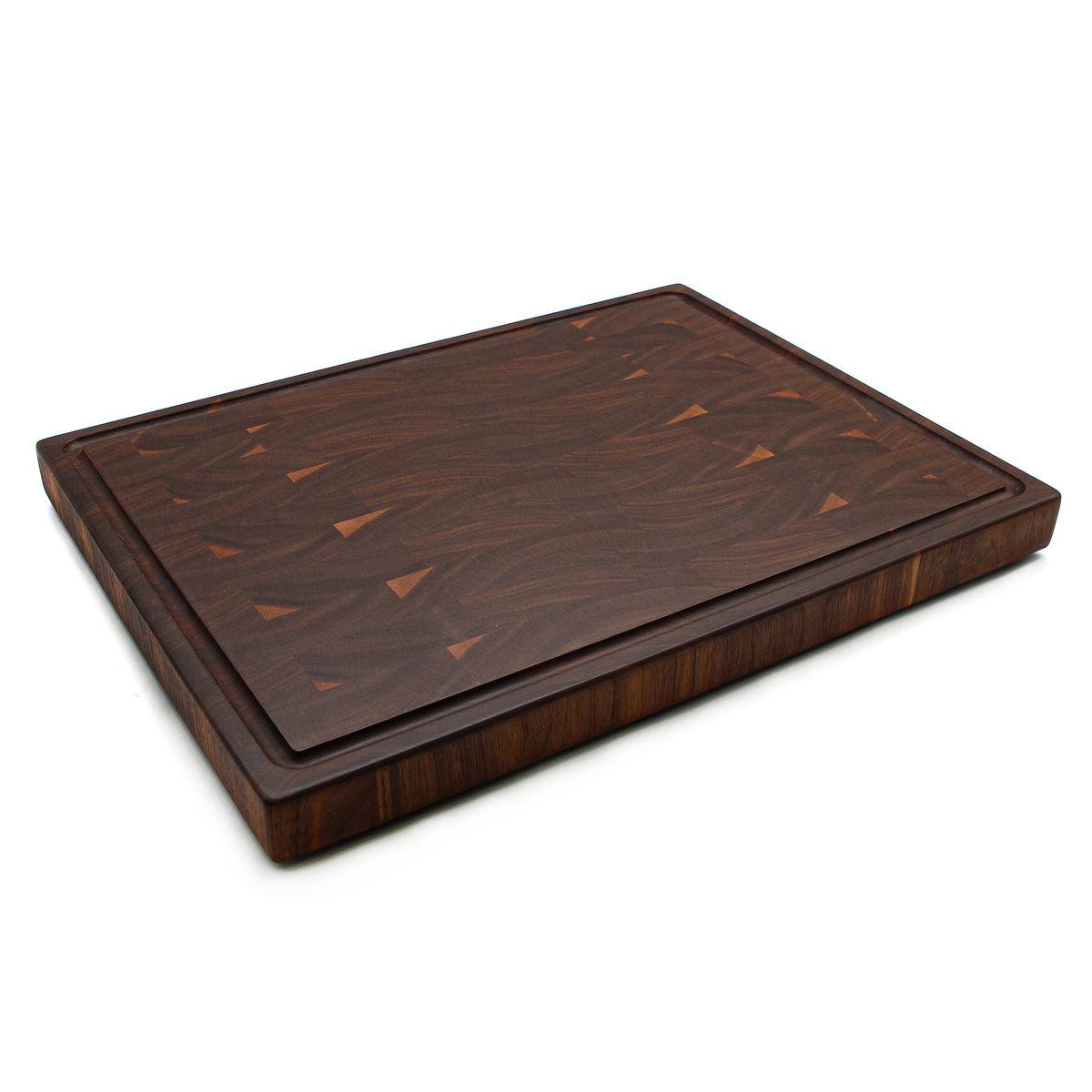 Walnut 20 × 15 end-grain cutting board with juice groove, angled view on white.