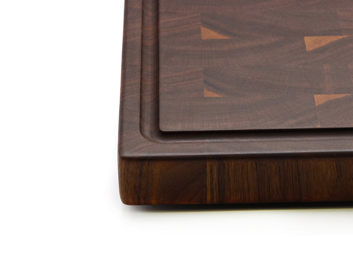 Detail of the walnut 20 × 15 end-grain board juice groove and corner.