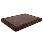 Walnut 20 × 15 end-grain cutting board with juice groove, low angled view showing its thickness.