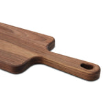 Close-up of the narrow paddle board handle, showing the rounded edge and hanging hole.