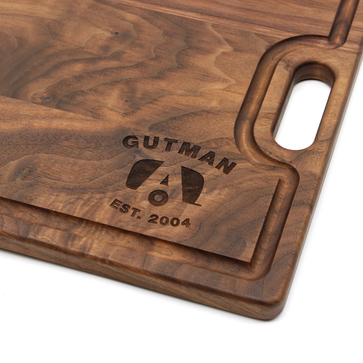 Close-up of the Airstream logo, Gutman name, and EST. 2004 engraved on a Walnut cutting board
